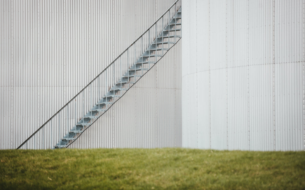 a rusty iron staircase in an industrial complex