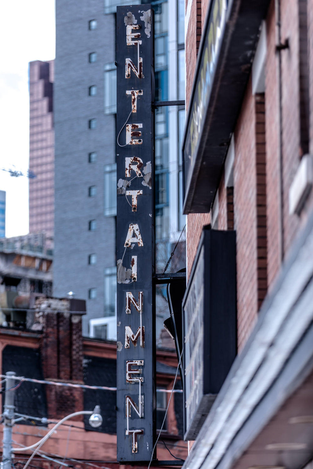 a rusty weather-worn sign on a building