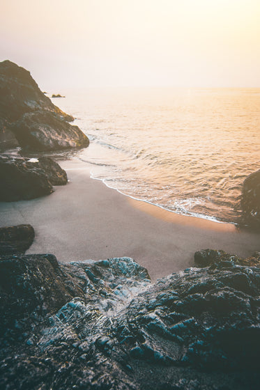 a secluded beach surrounded by cliffs