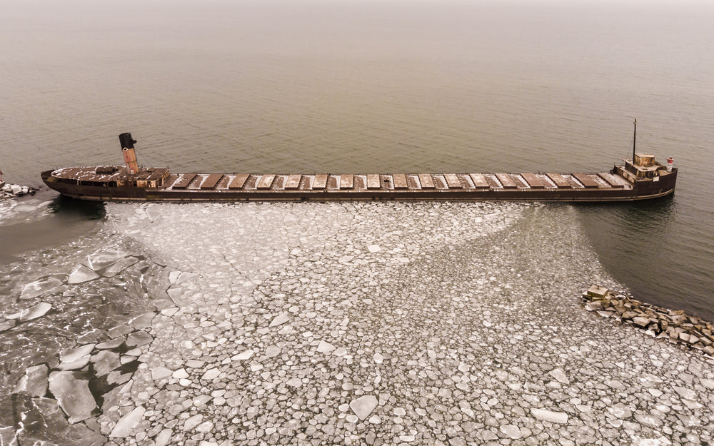 a ship maintains the ice on misty water