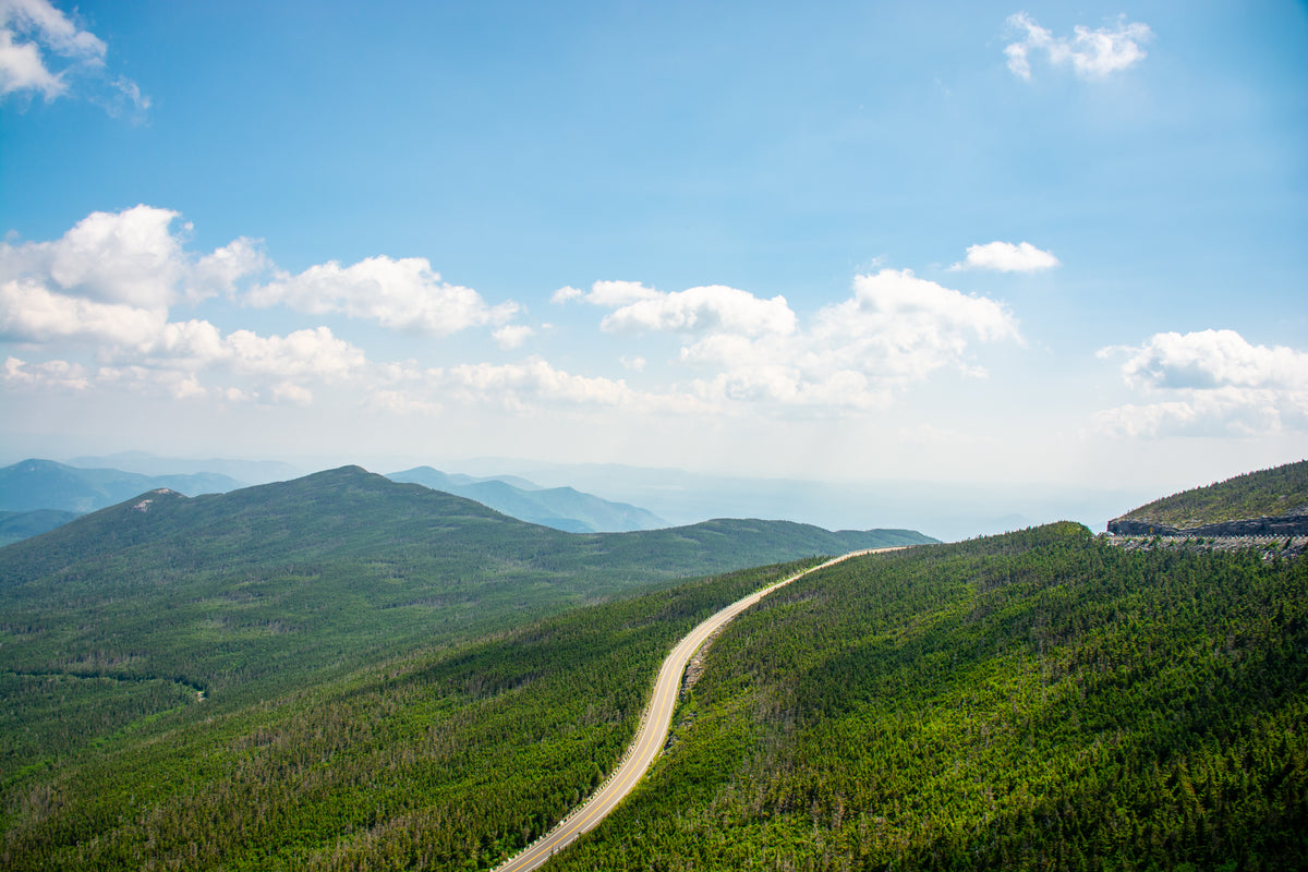 a single highway swirls through a hilly landscape