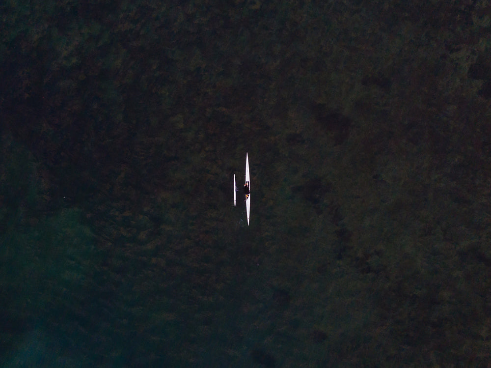 a single rower gliding through clear water