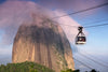 a square gondola and black cables reach up to a mountain