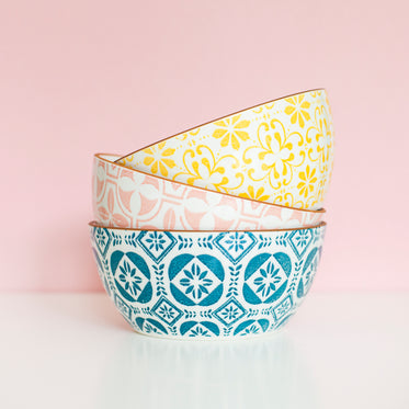 a stack of three patterned bowls of differing colors
