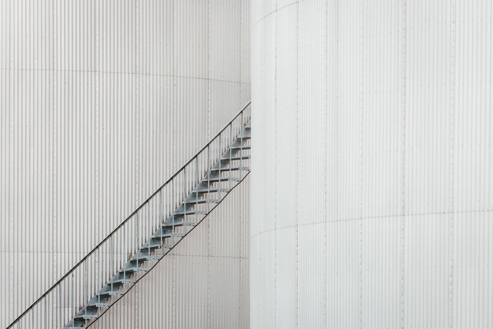 a staircase emerges from between two buildings