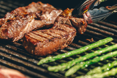 a steak on a grill right after being flipped