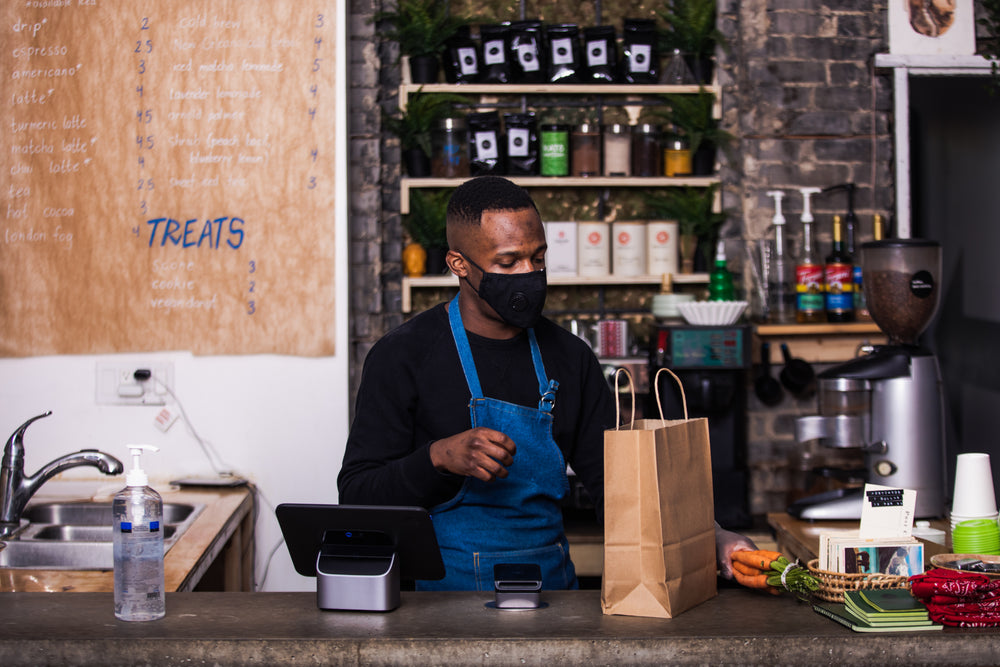 a store owner cashes out someones groceries