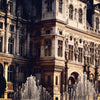 a sun-kissed baroque building overlooking water fountains
