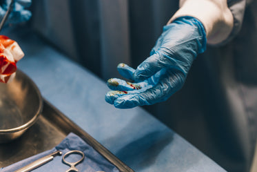 a surgeon handles gauze pad and surgical equipment