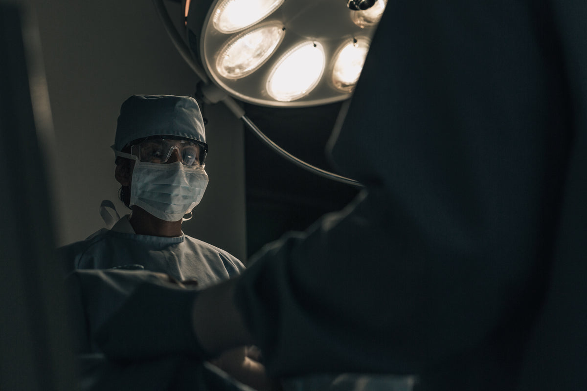a surgeon in scrubs mid-operation
