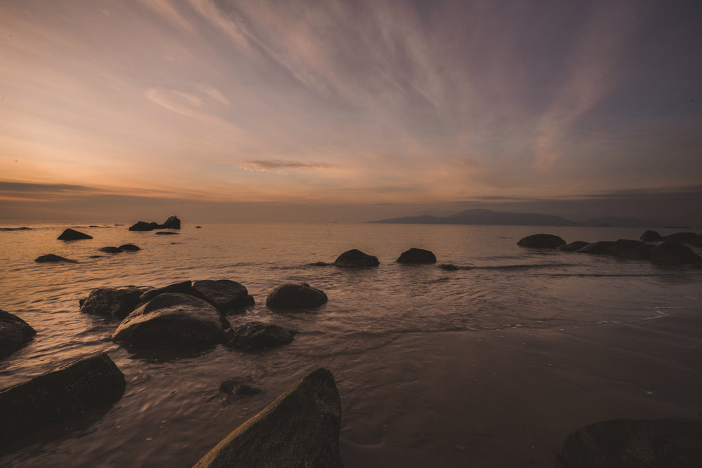 a sweeping sunset illuminating a beach