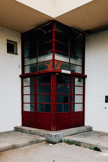 a symmetrical building entrance with red doors
