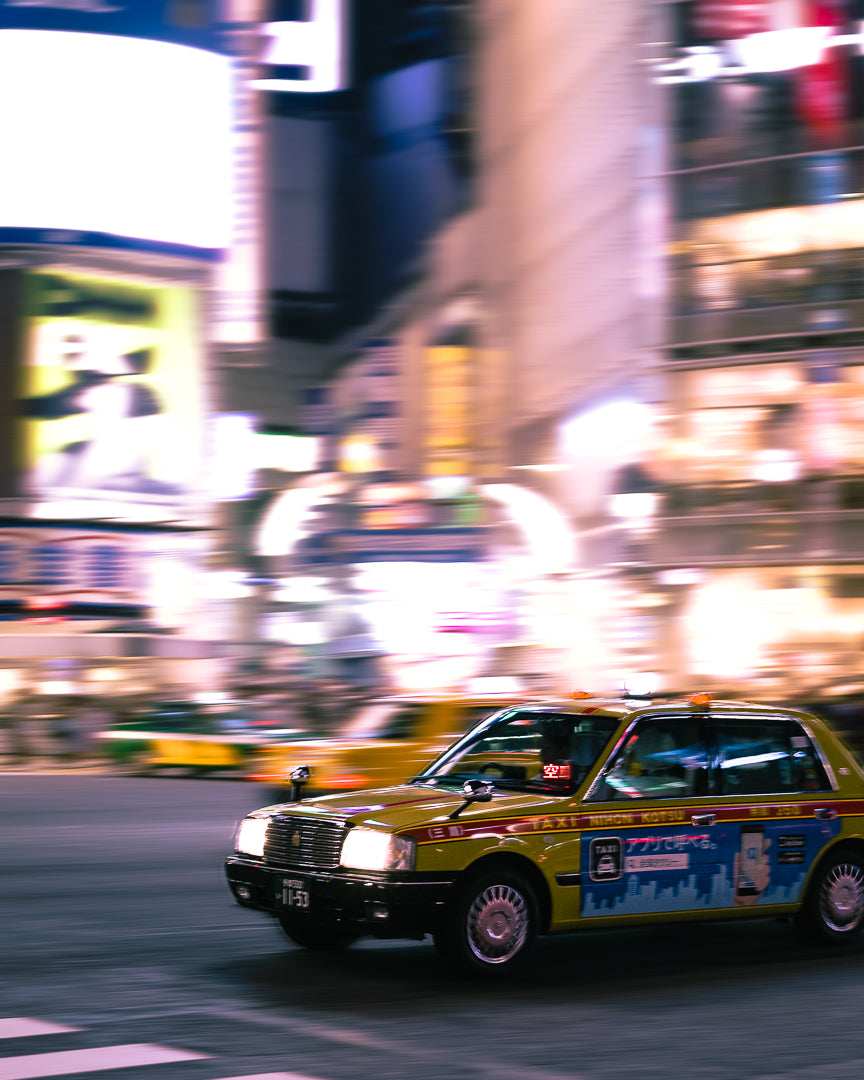 a taxi in japan hurtles through city streets