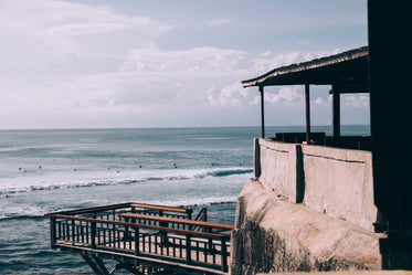 a thatch roofed bar perched on a rocky alcove