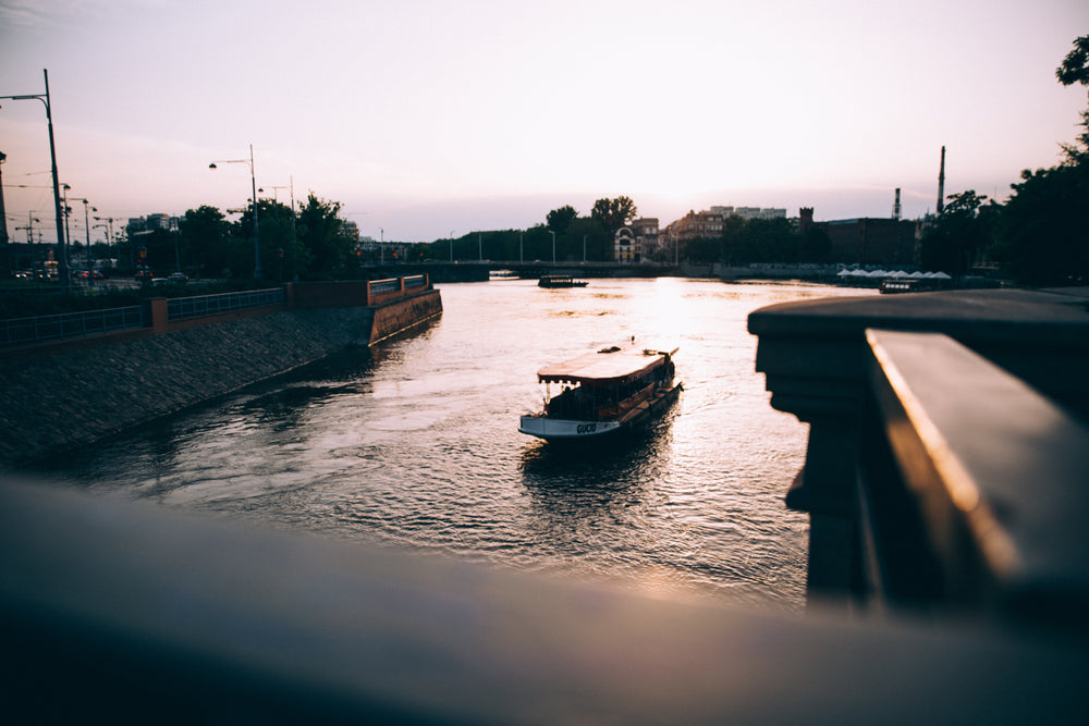 a tourist boat on a river at sunset