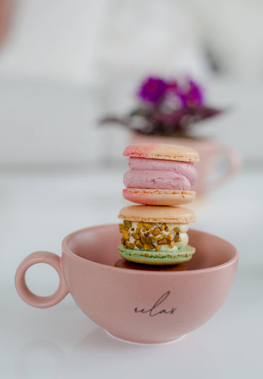 a tower of macarons in a teapot
