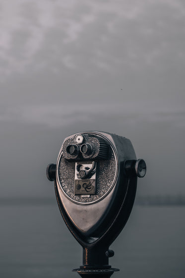 a tower viewer overlooks a watery grey shoreline