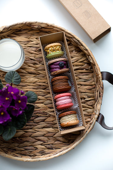 a tray with macarons and flowers