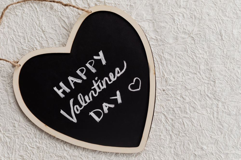 a valentine's day message written on a blackboard
