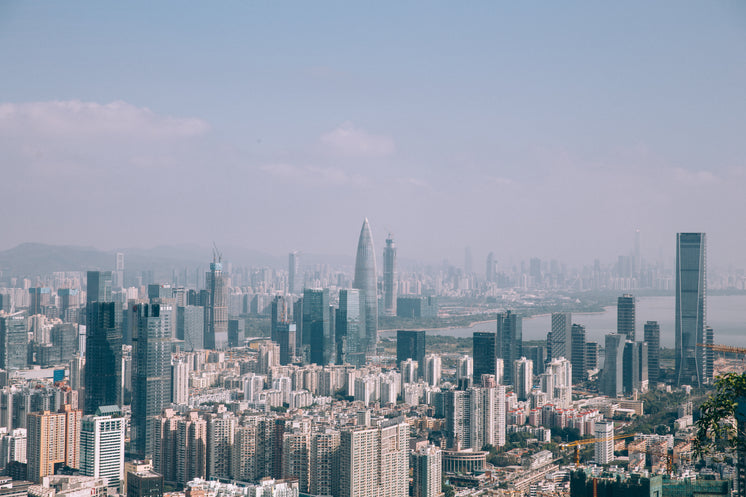 A Vast Expanse Of Skyscrapers Blend Into A Hazy Sky