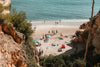 a view from a cliff onto a sandy beach
