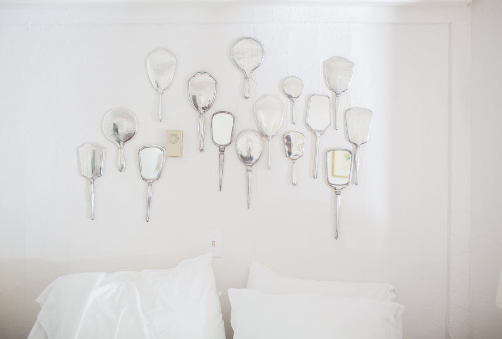 a wall of hand mirrors