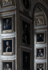 a wall of painted portraits