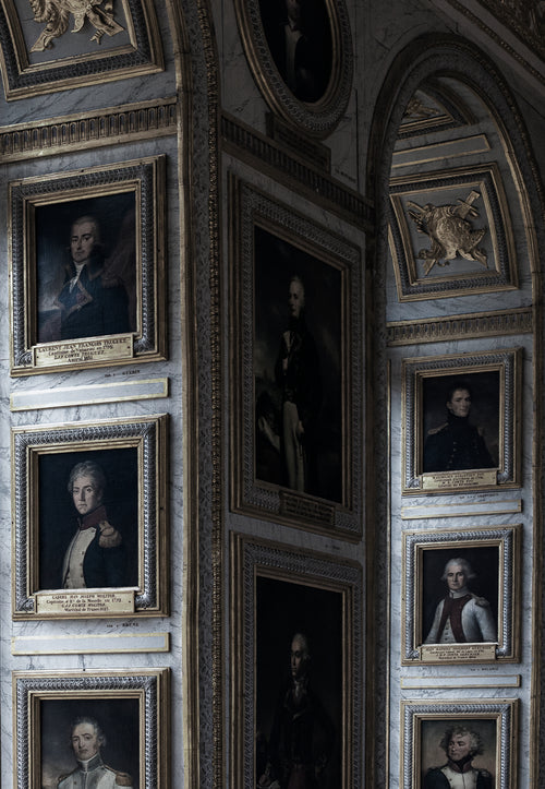 a wall of painted portraits
