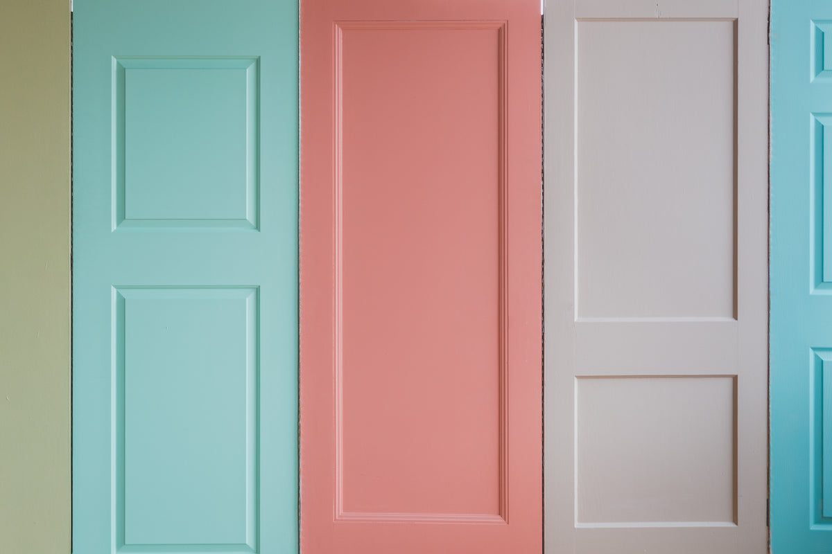 a wall of pastel colored doors