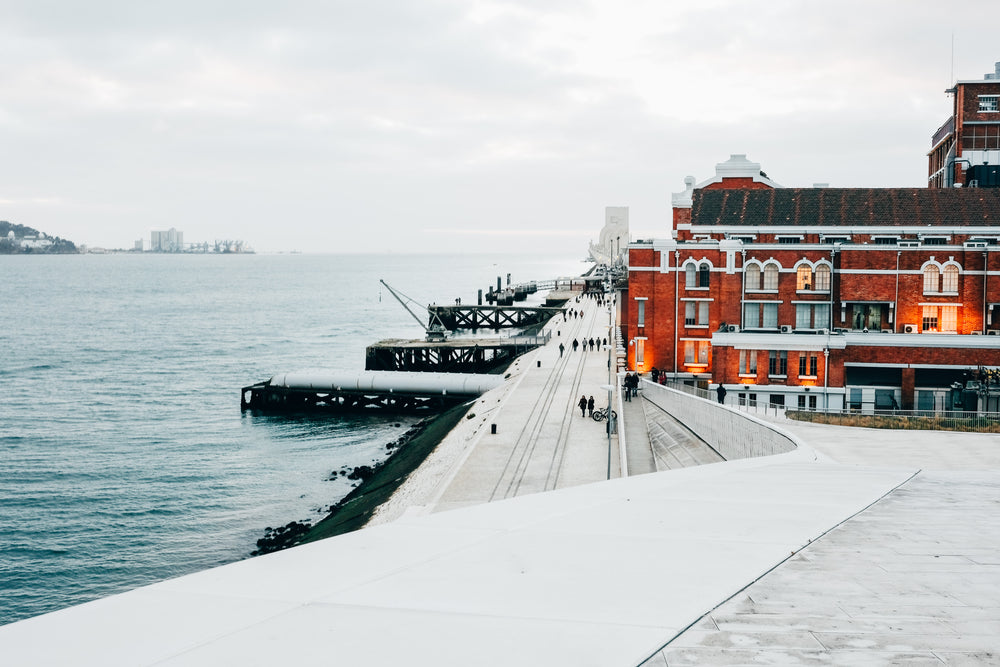 a warm red brick building by the cold docks