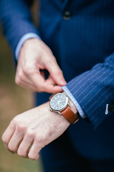 a watch and pinstripe suit