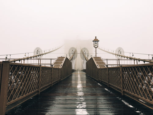 a wet bridge covered in fog