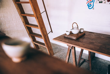 a white tea set on a wooden table