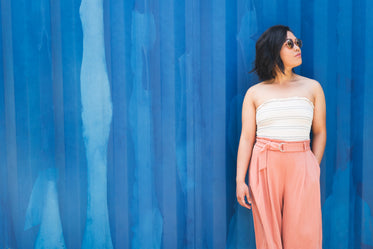 a woman against a primary blue wall