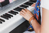 a woman plays the piano