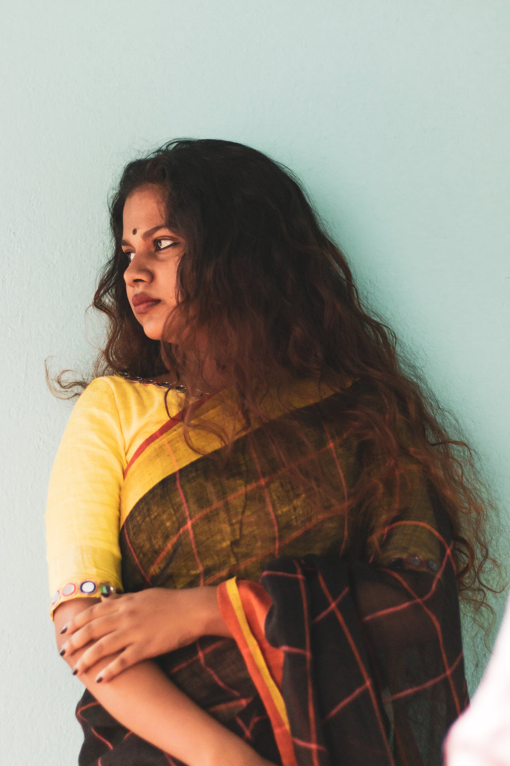 a woman posing for photos against wall