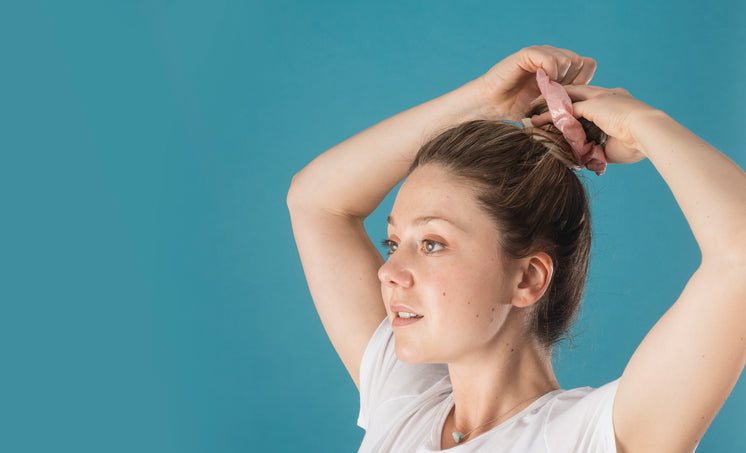 a-woman-putting-her-hair-up-with-a-pink-scrunchie.jpg?width=746&format=pjpg&exif=0&iptc=0