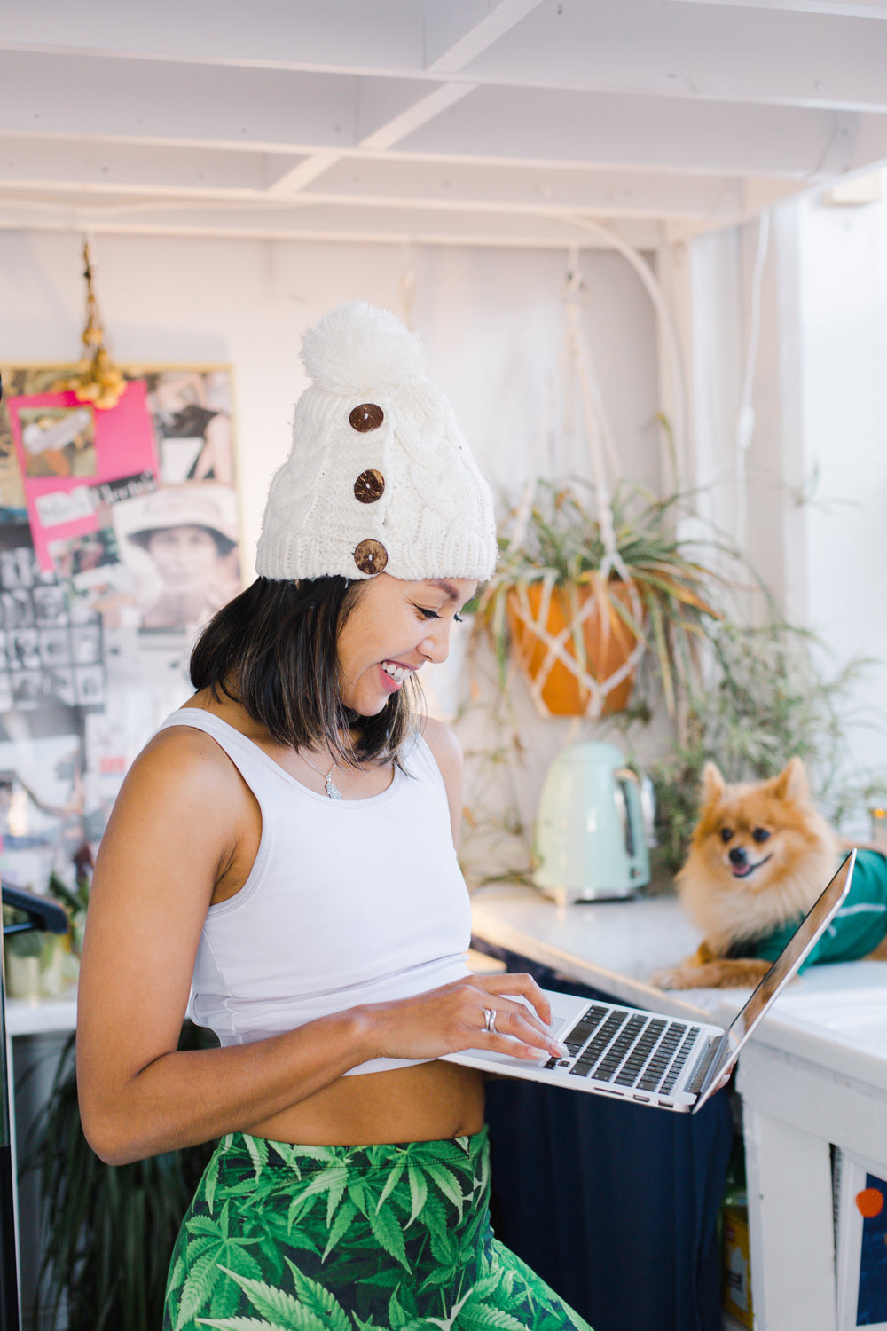 a woman smiles at her laptop