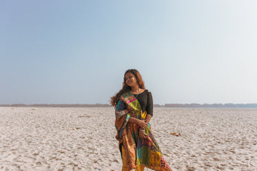 a woman standing in the sand