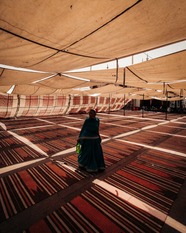 a woman standing under a large tent