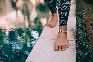 a woman walks along side the water