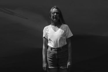 a woman wearing a white shirt and jean shorts