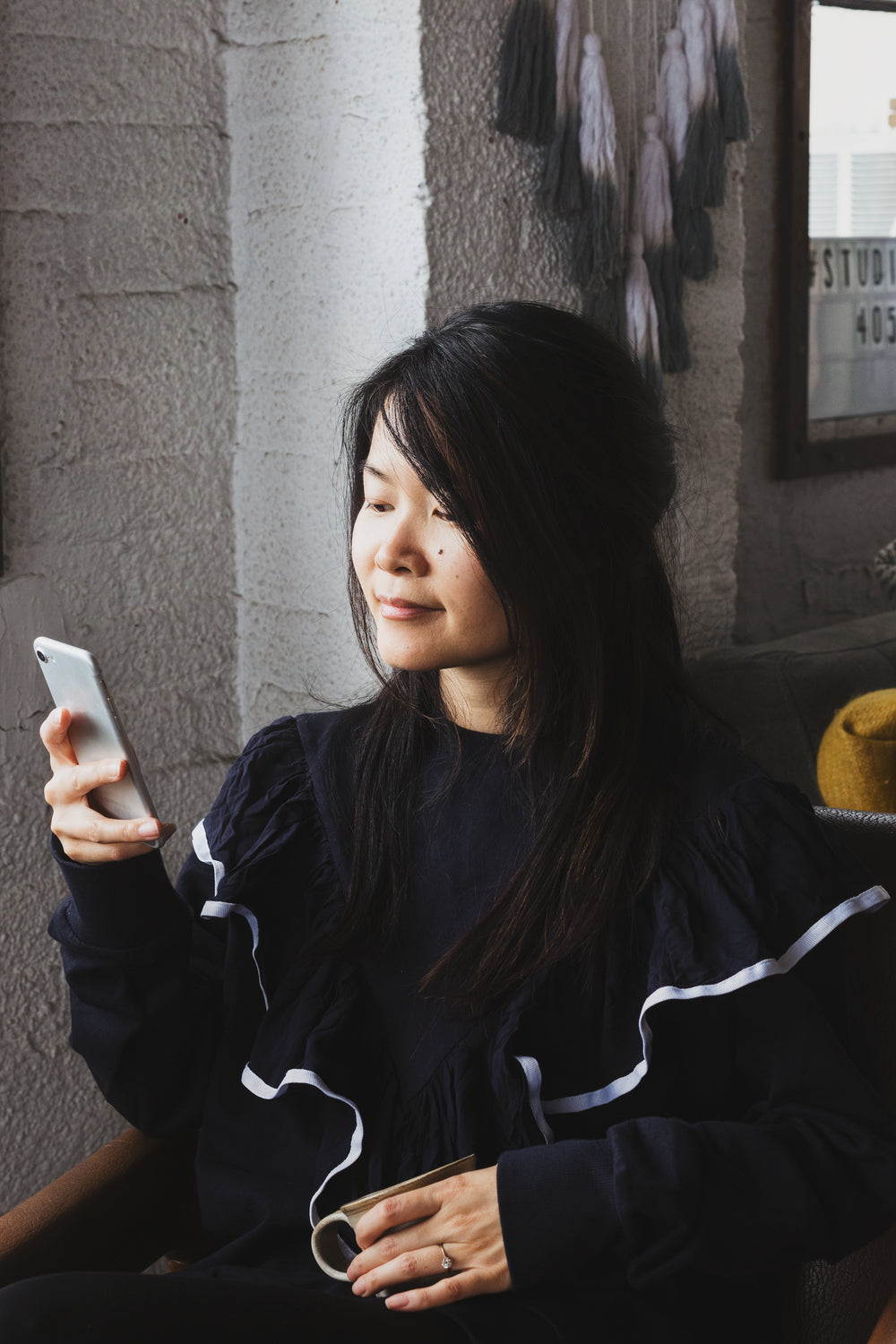 a woman with mobile and coffee