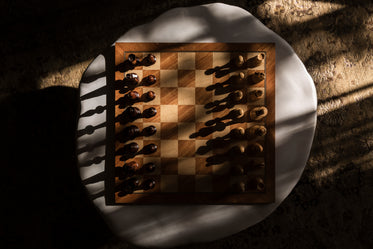 a wooden chess board at the start of the game