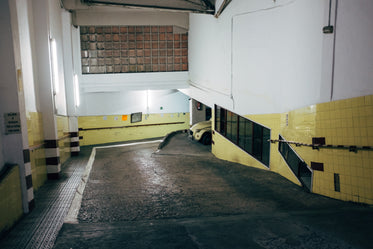 a yellow bug car peeks round a corner in a carpark