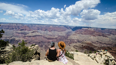 a young man and woman chat over a canyon