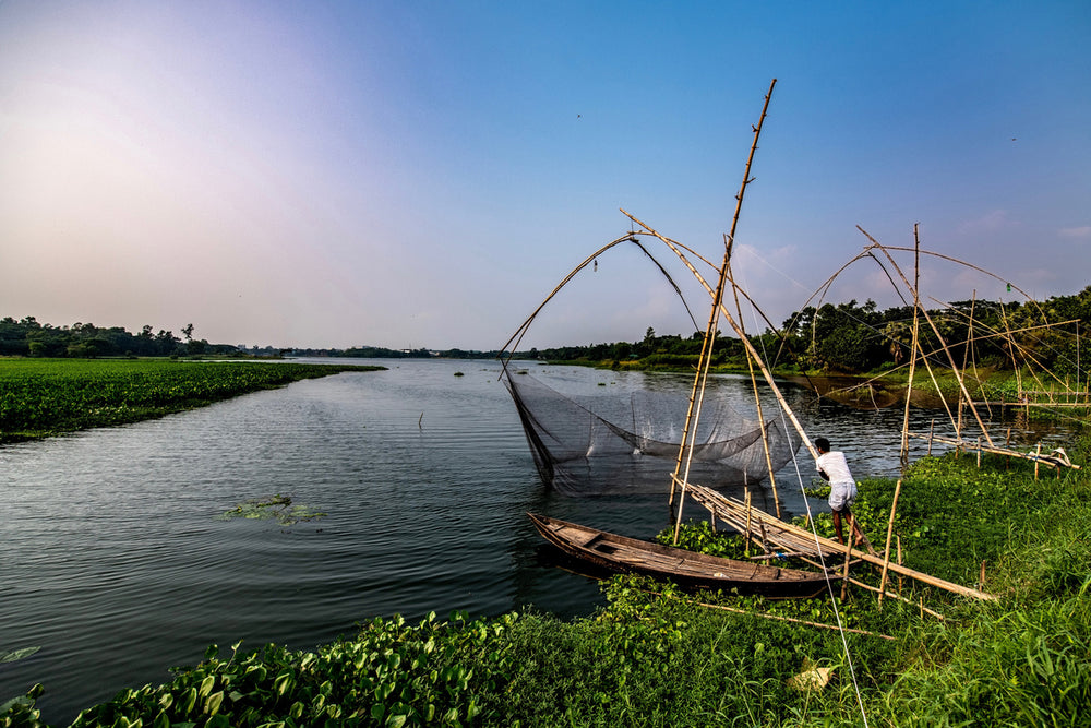 a young man pulling in a fishing net