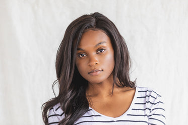 a young woman posing in a black and white shirt