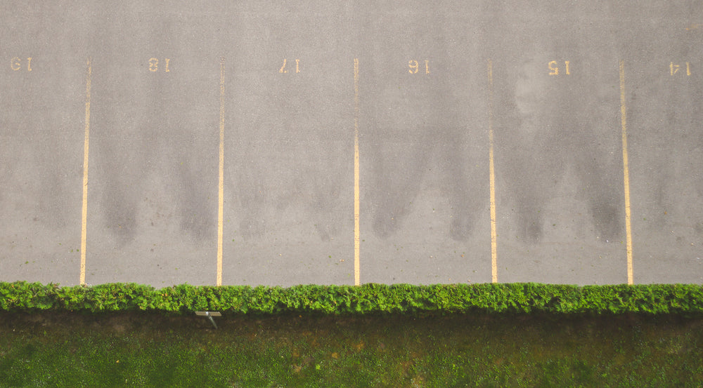 aerial image of parking spaces by grass