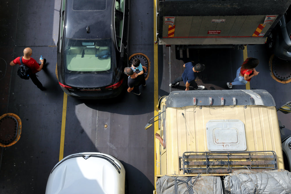 aerial image of people walking between stopped traffic